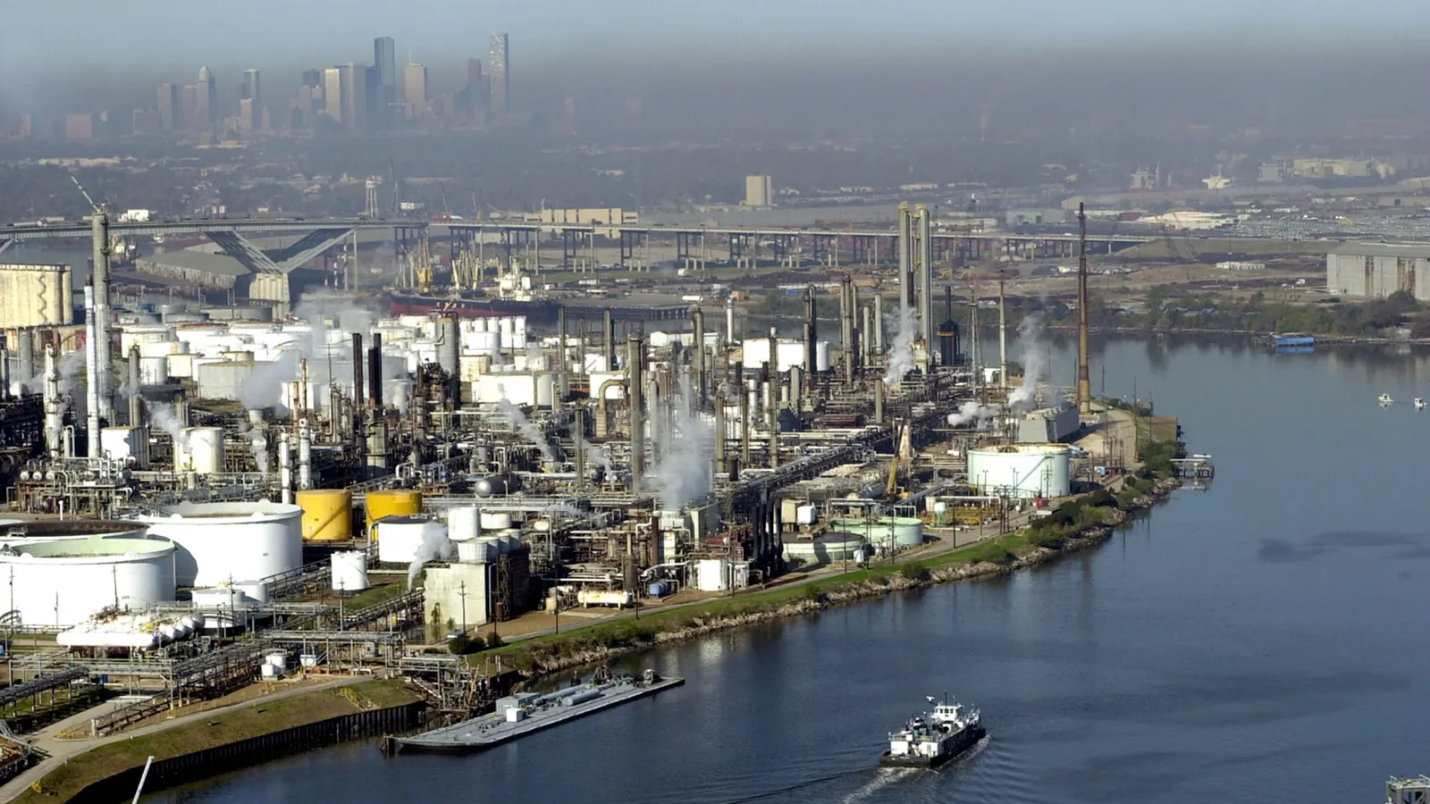 Refineries along the Houston Ship Channel, with downtown Houston behind