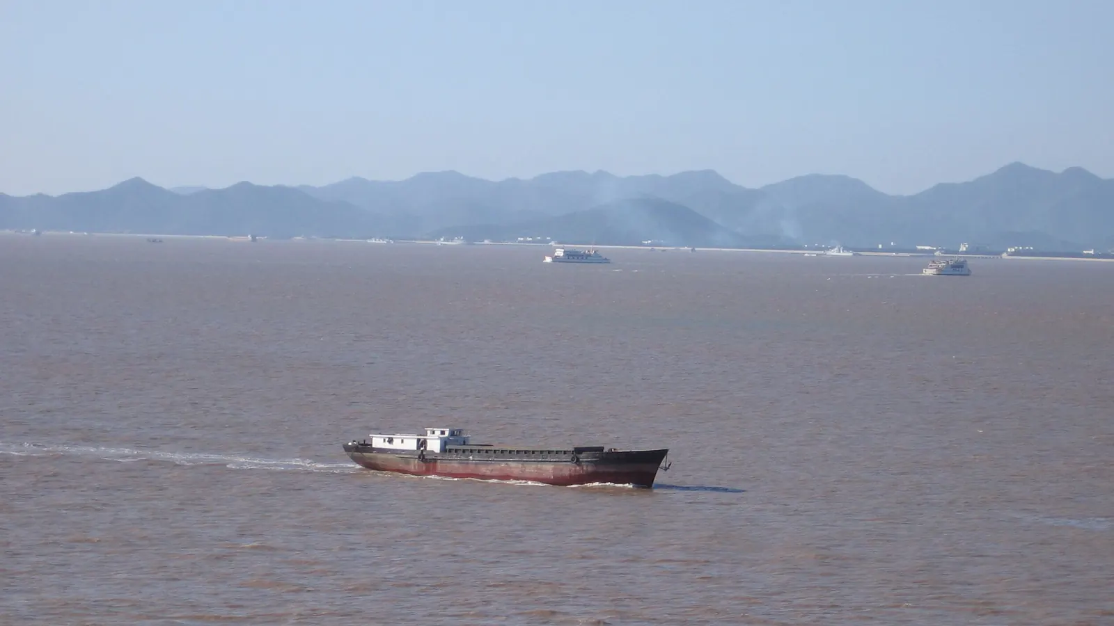 A coastal vessel in the waters of Ningbo-Zhoushan port, with the islands behind